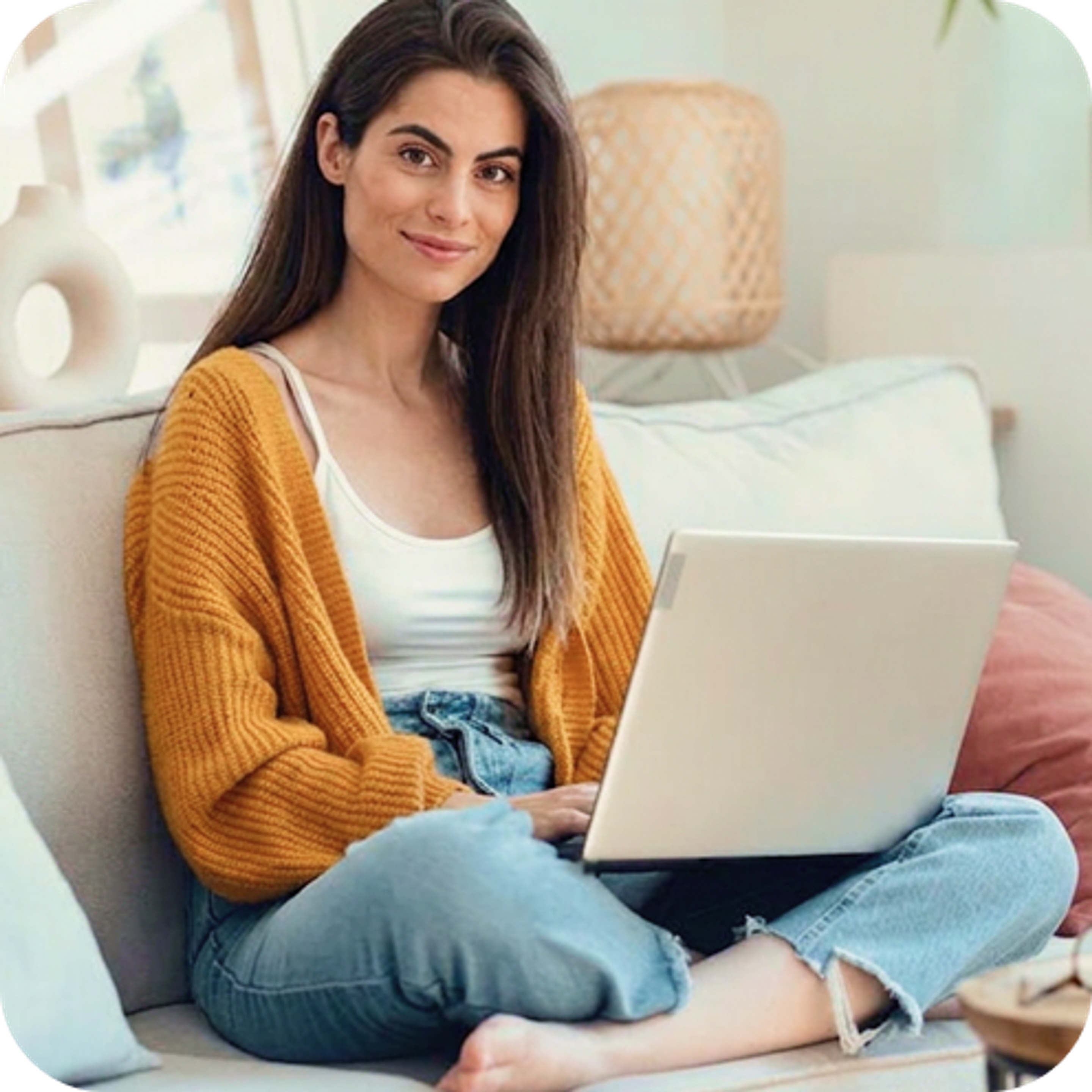 Lady with laptop sitting on sofa