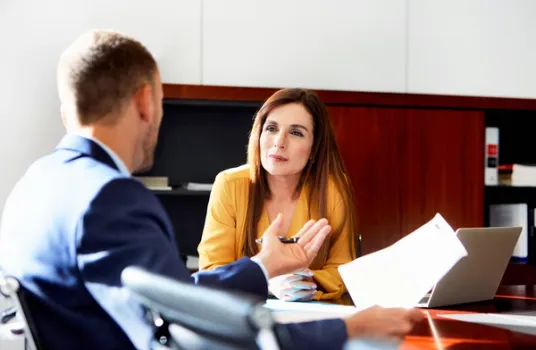 Male and female coworker having a converation in the office