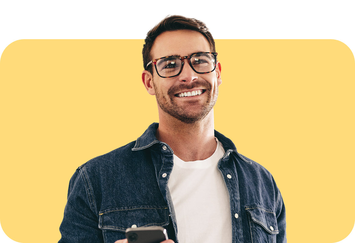 smiling man in denim shirt with iPhone
