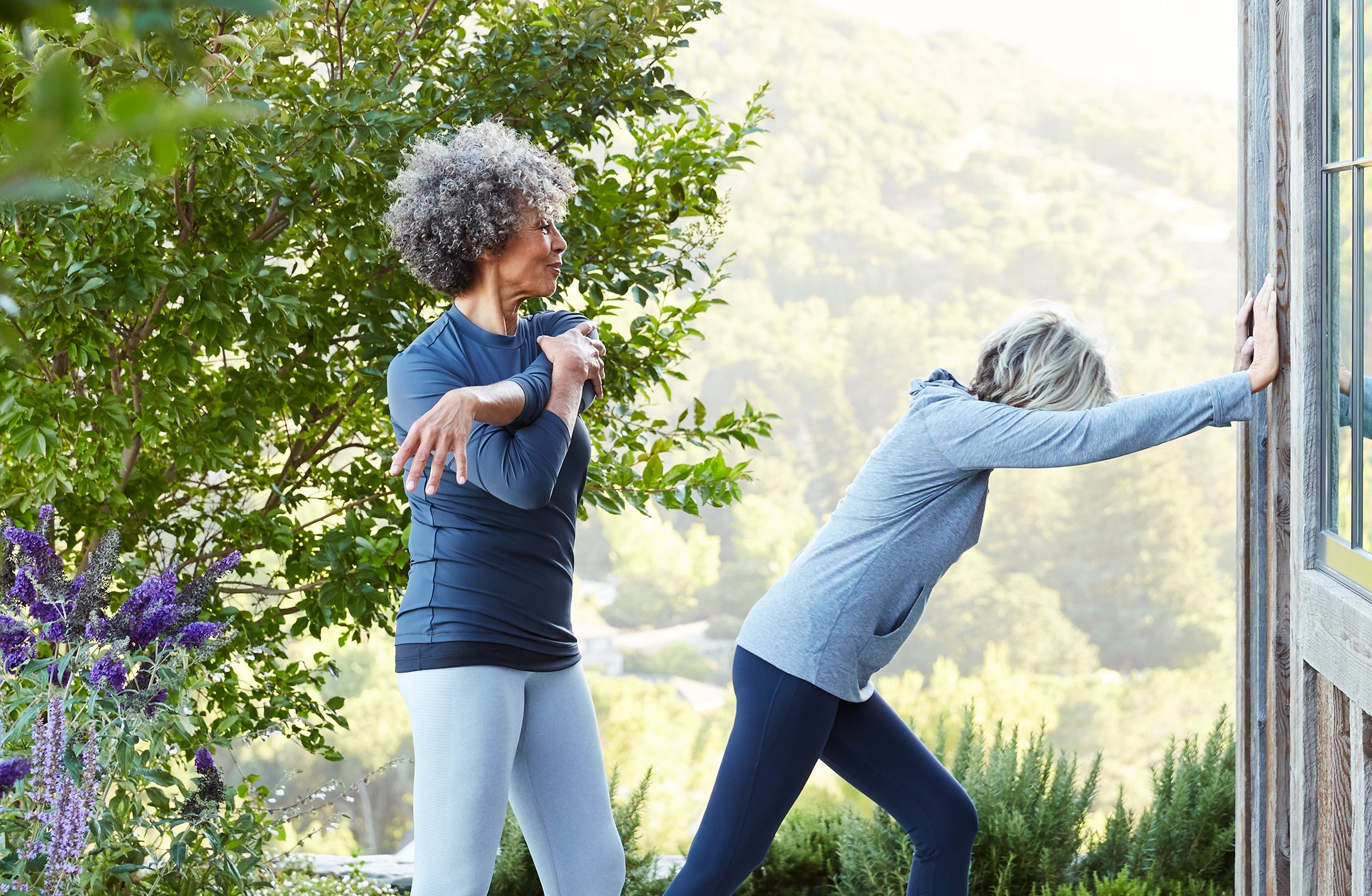 Two women stretching outside