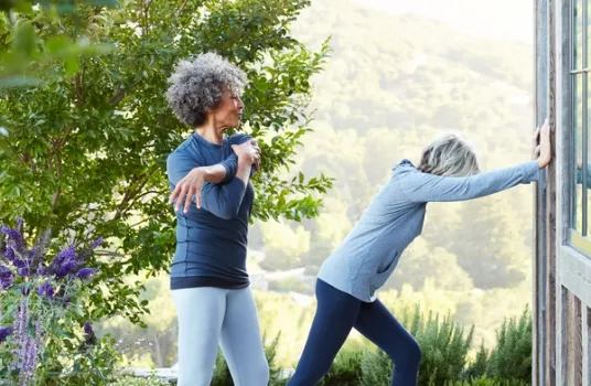 Two women stretching outside