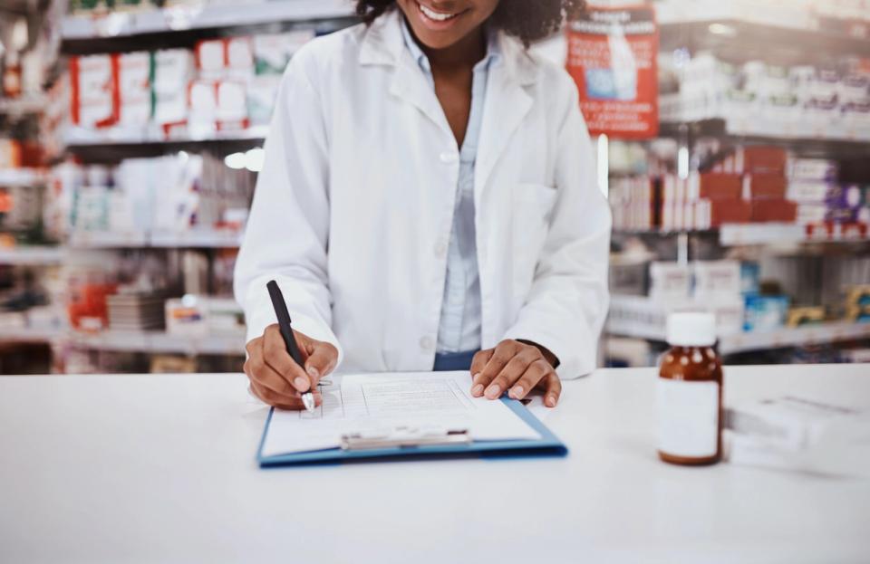 female pharmacist at pharmacy counter 