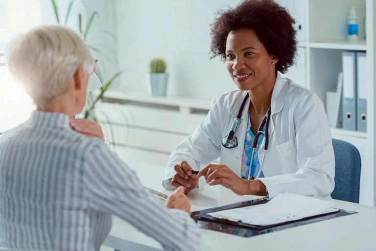 woman sitting and talking with a doctor