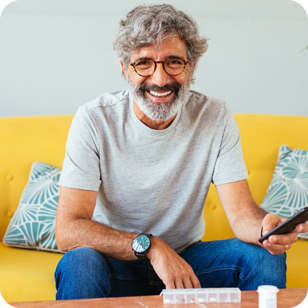Man smiling using phone
