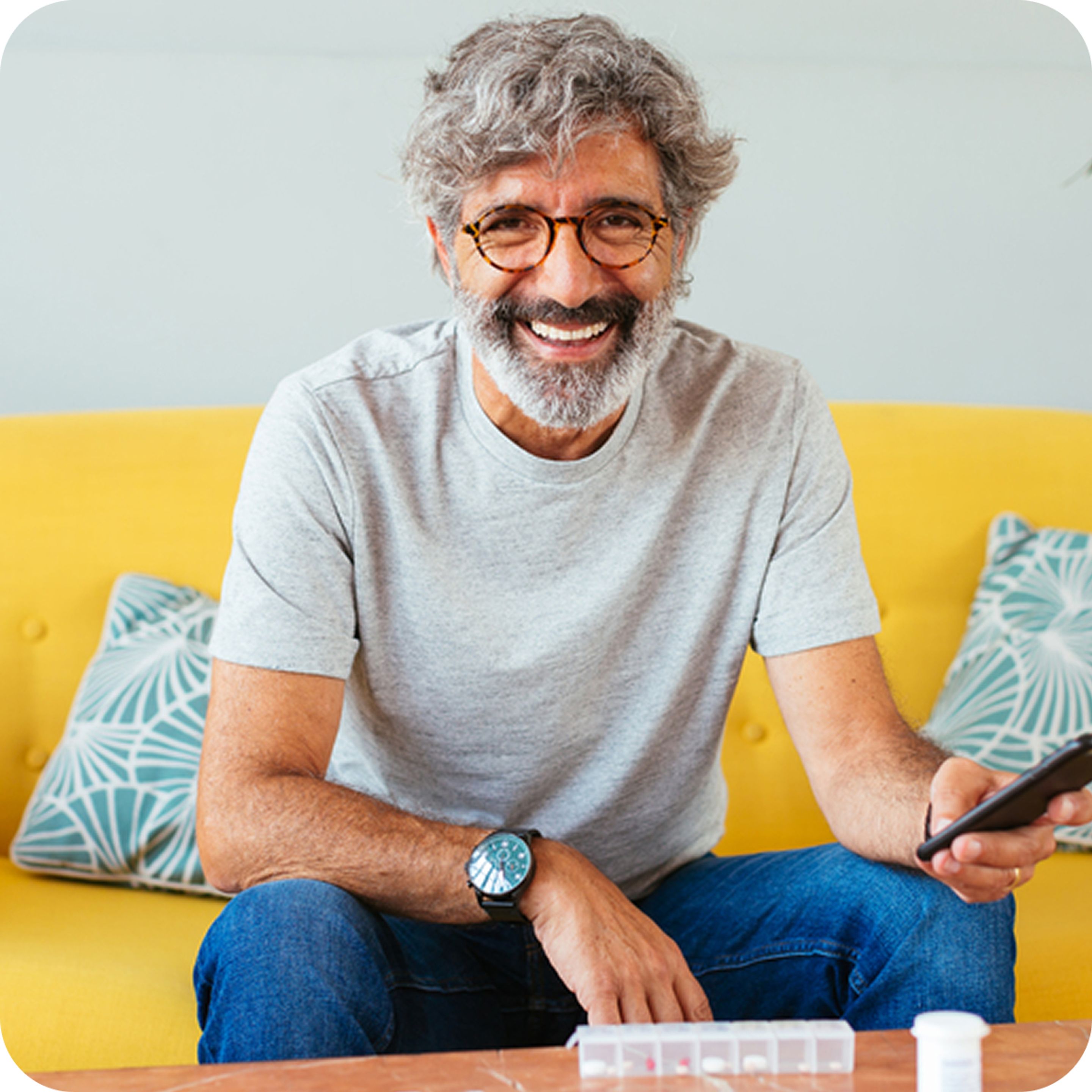 Man smiling using phone