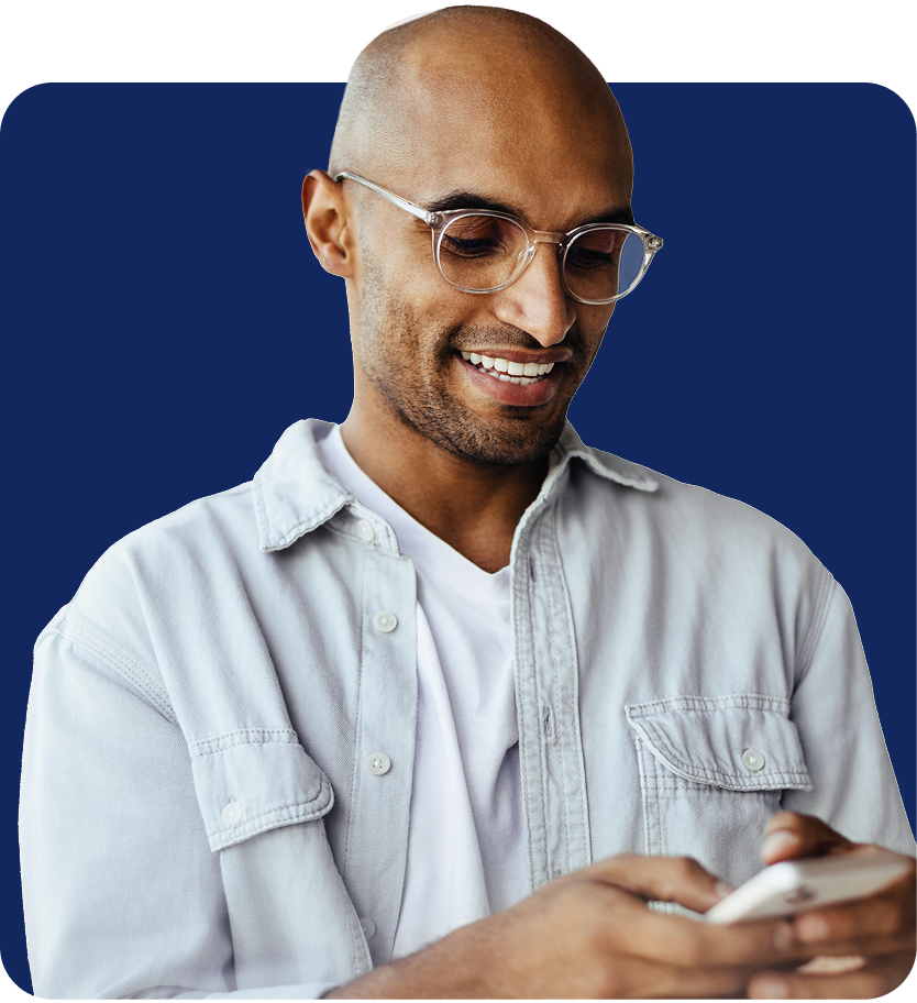 man smiling looking at phone