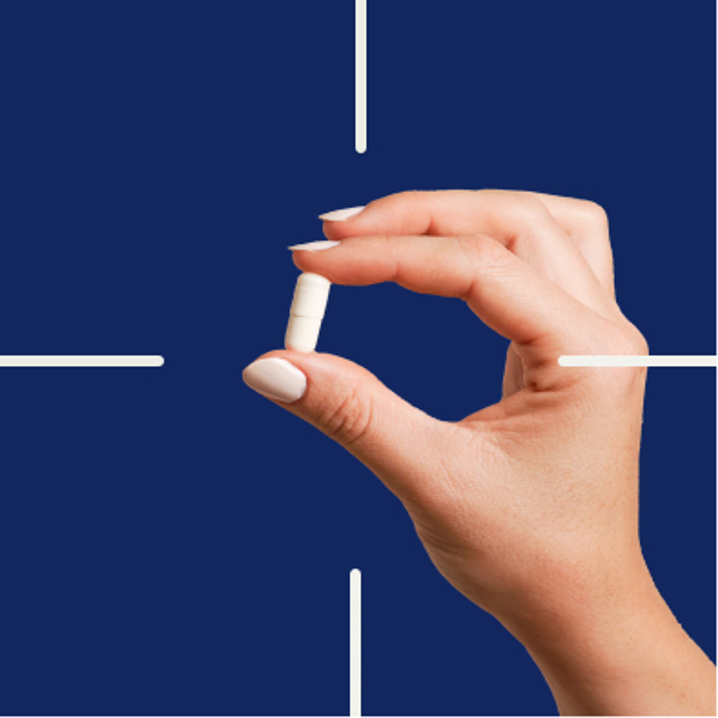 Hand holding a pill