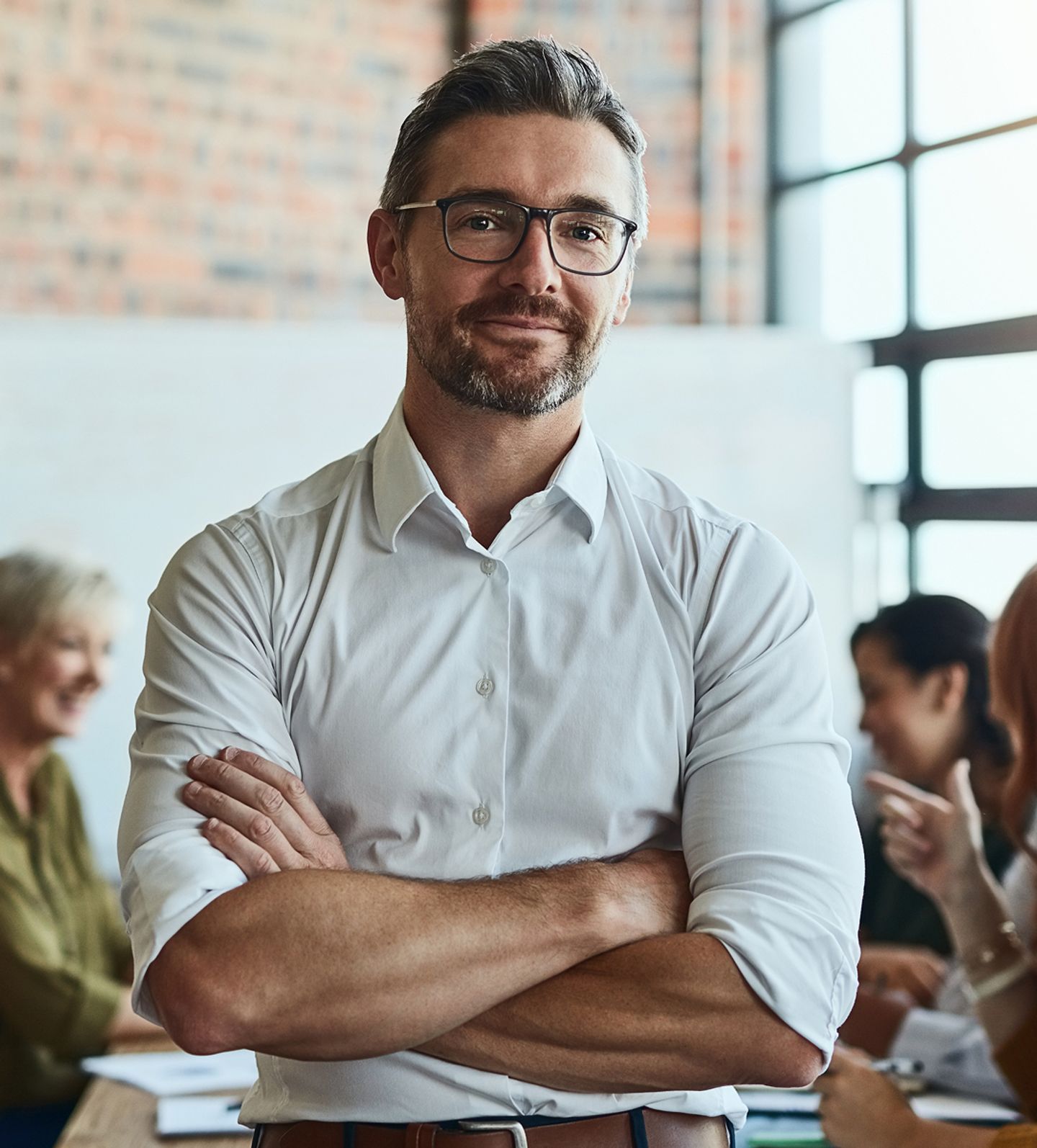 Man smiling with arms crossed
