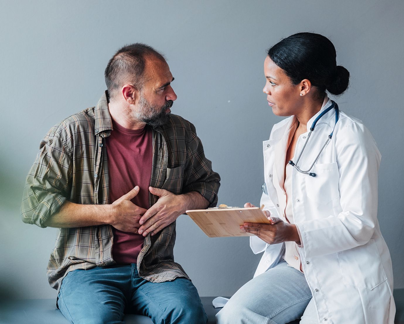 Man discussing symptoms with a female provider
