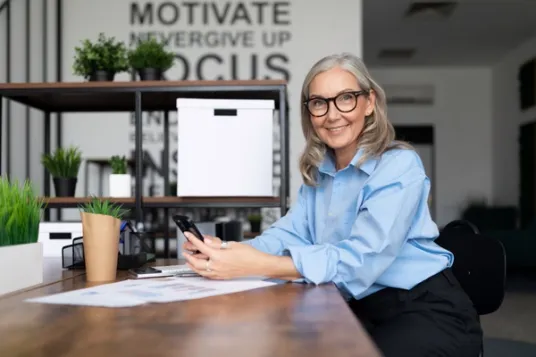 Woman sitting at desk in professional clothing