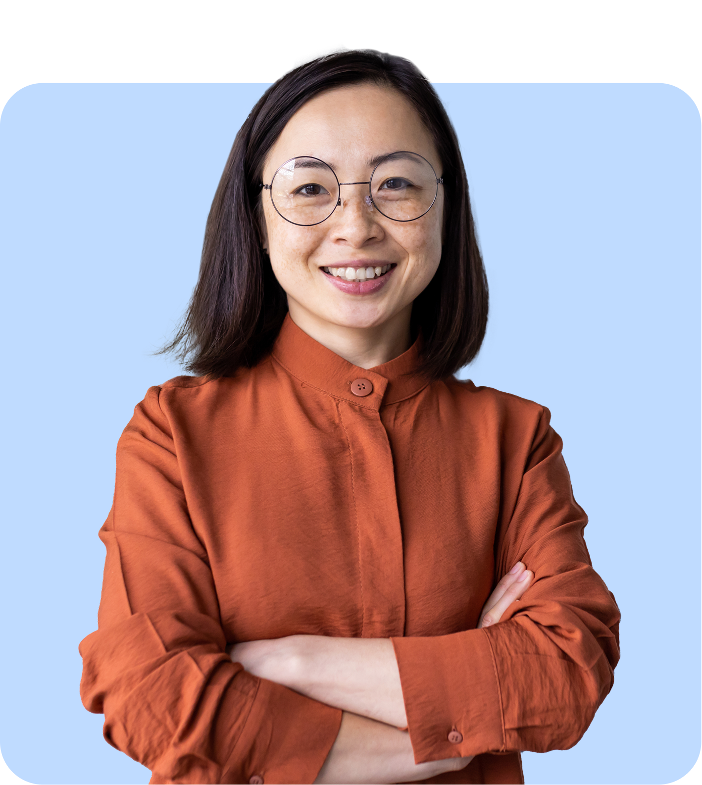 smiling lady with glasses arms folded