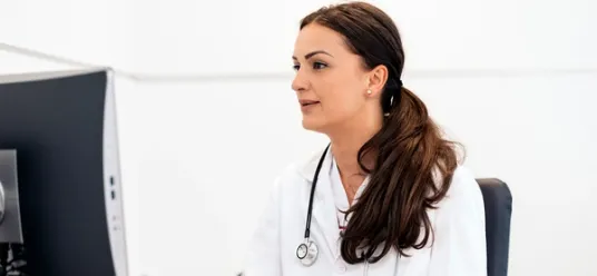 Female doctor sitting at computer