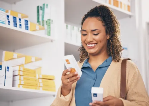 Woman in pharmacy comparing two medications