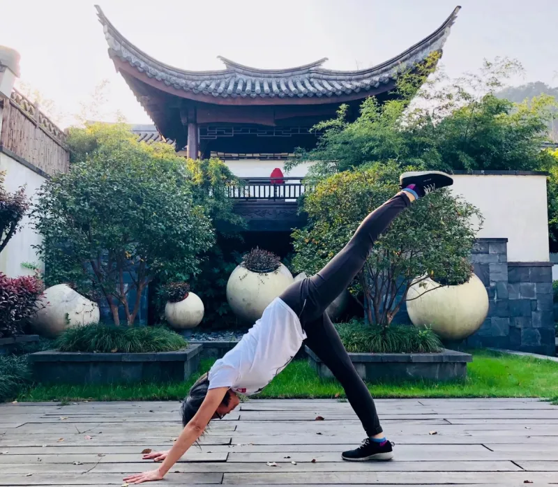 Fawn Glen doing yoga in a traditionalChinese garden