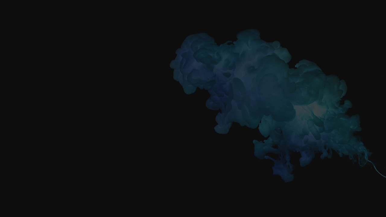 Blue and teal smoke cloud billowing against a dark background.