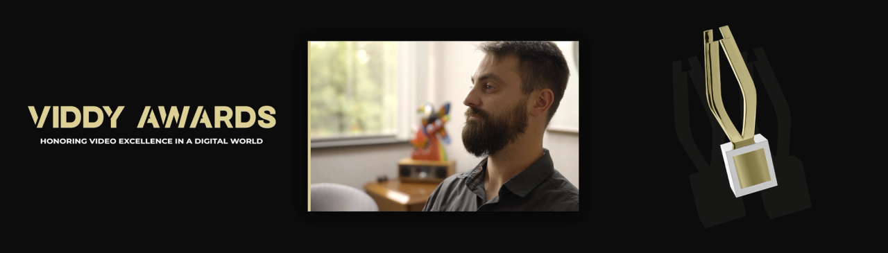 Viddy Awards logo, man with beard in profile, trophy graphic on black background.