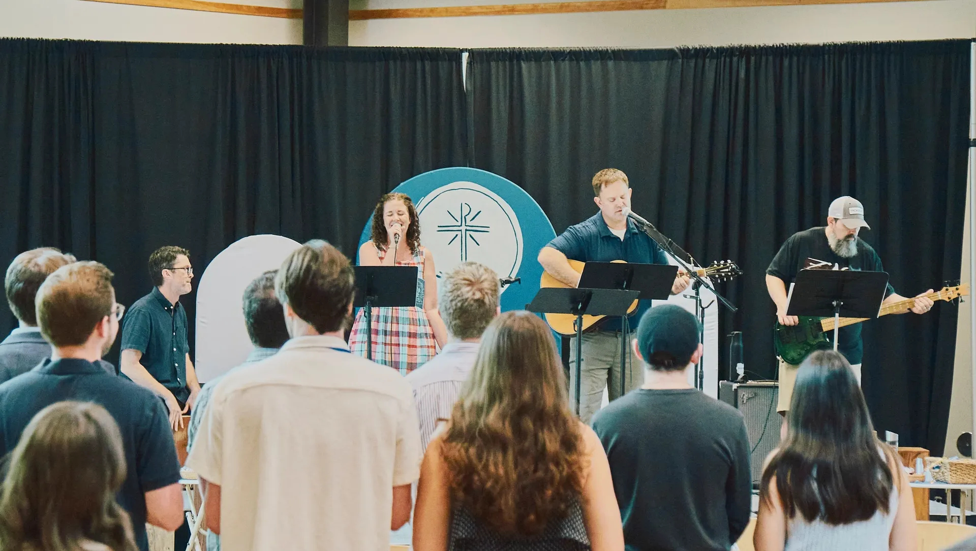 The Hope worship team leading Sunday morning worship with acoustic guitar and congregational singing.