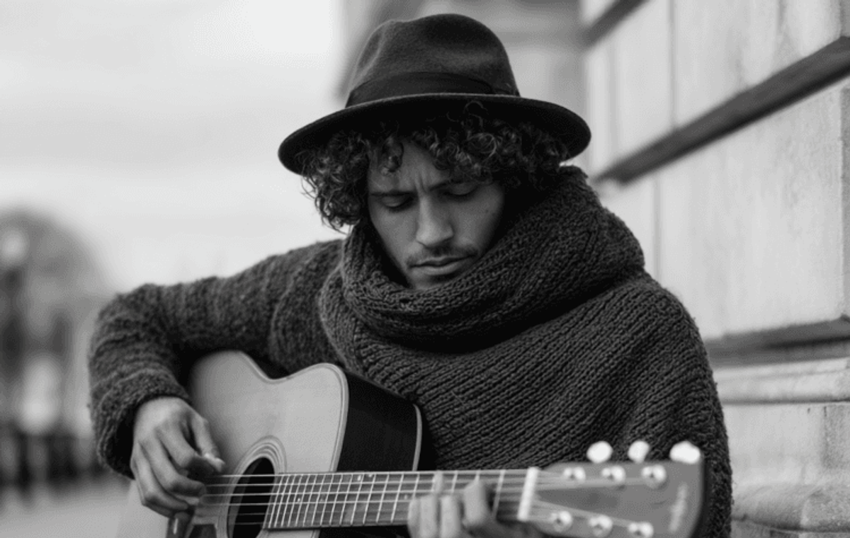 Man in hat playing acoustic guitar