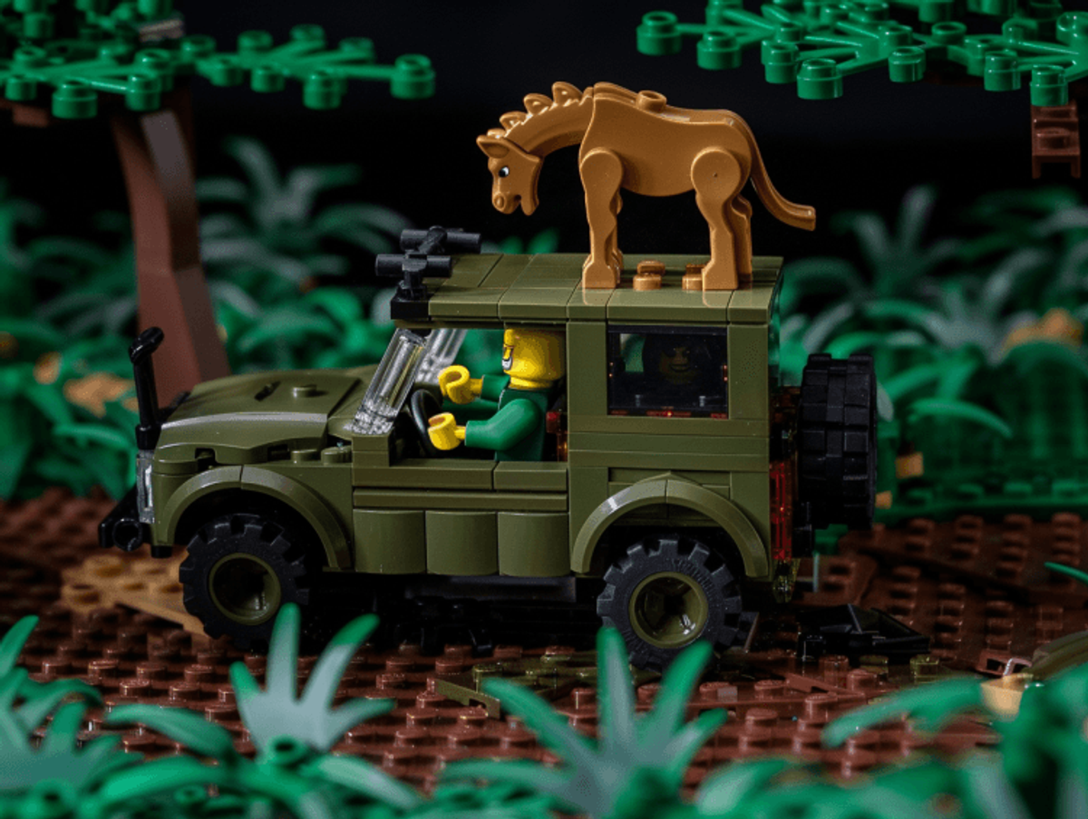Lego safari jeep with lion on roof.