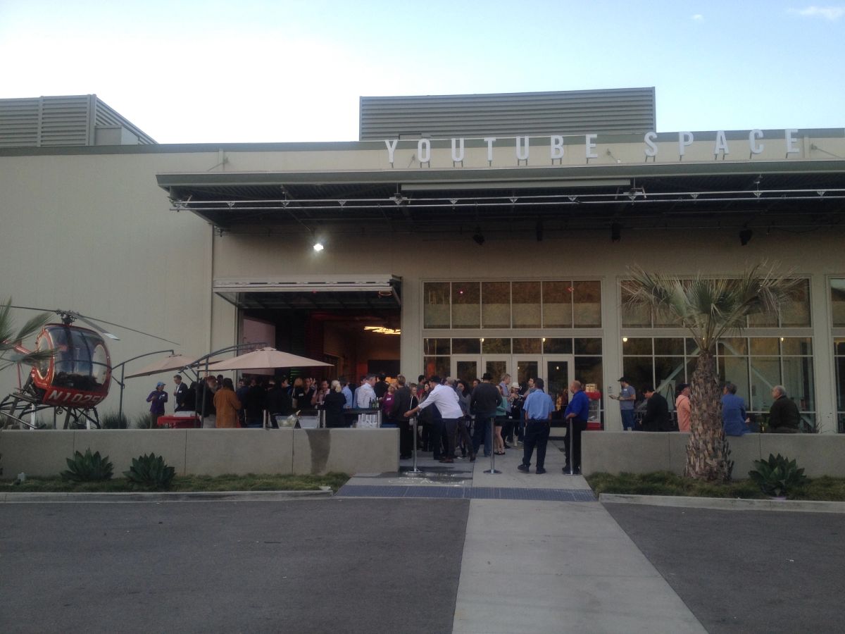 The entrance of YouTube Space LA in 2014, with a crowd gathered on the patio under the YouTube Space lettering