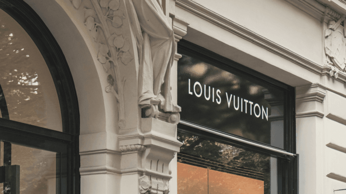 Entrance of Louis Vuitton store with detailed architecture.