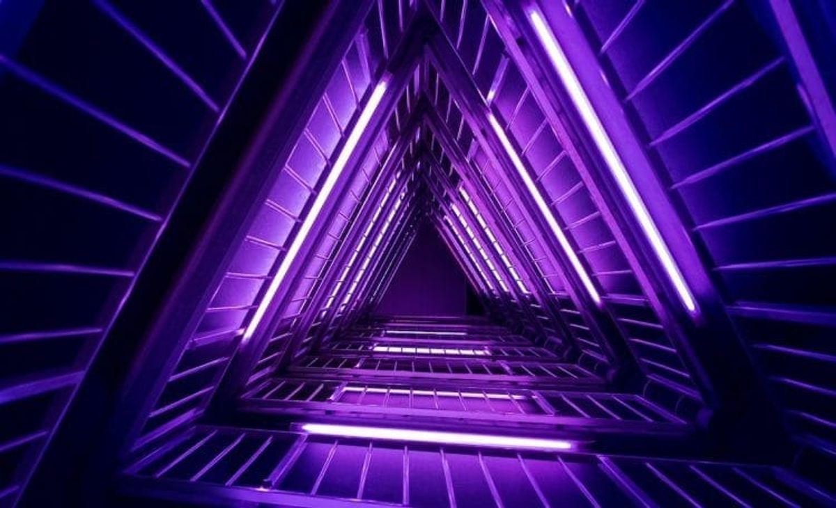 Futuristic purple neon triangular structure.