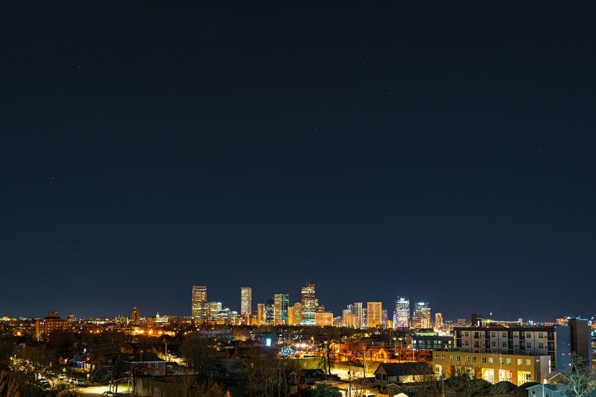 Denver Colorado skyline with Rocky Mountains backdrop - Event Management in Denver