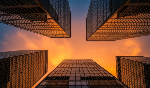 Modern glass skyscrapers reflecting sunset - best crypto and Web3 PR agencies
