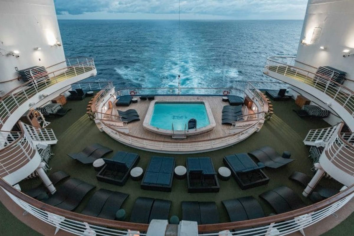 Cruise ship pool deck overlooking the ocean.