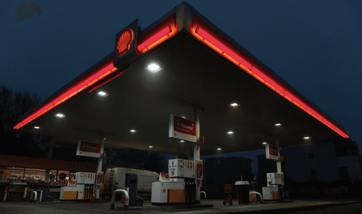 Illuminated gas station at night.