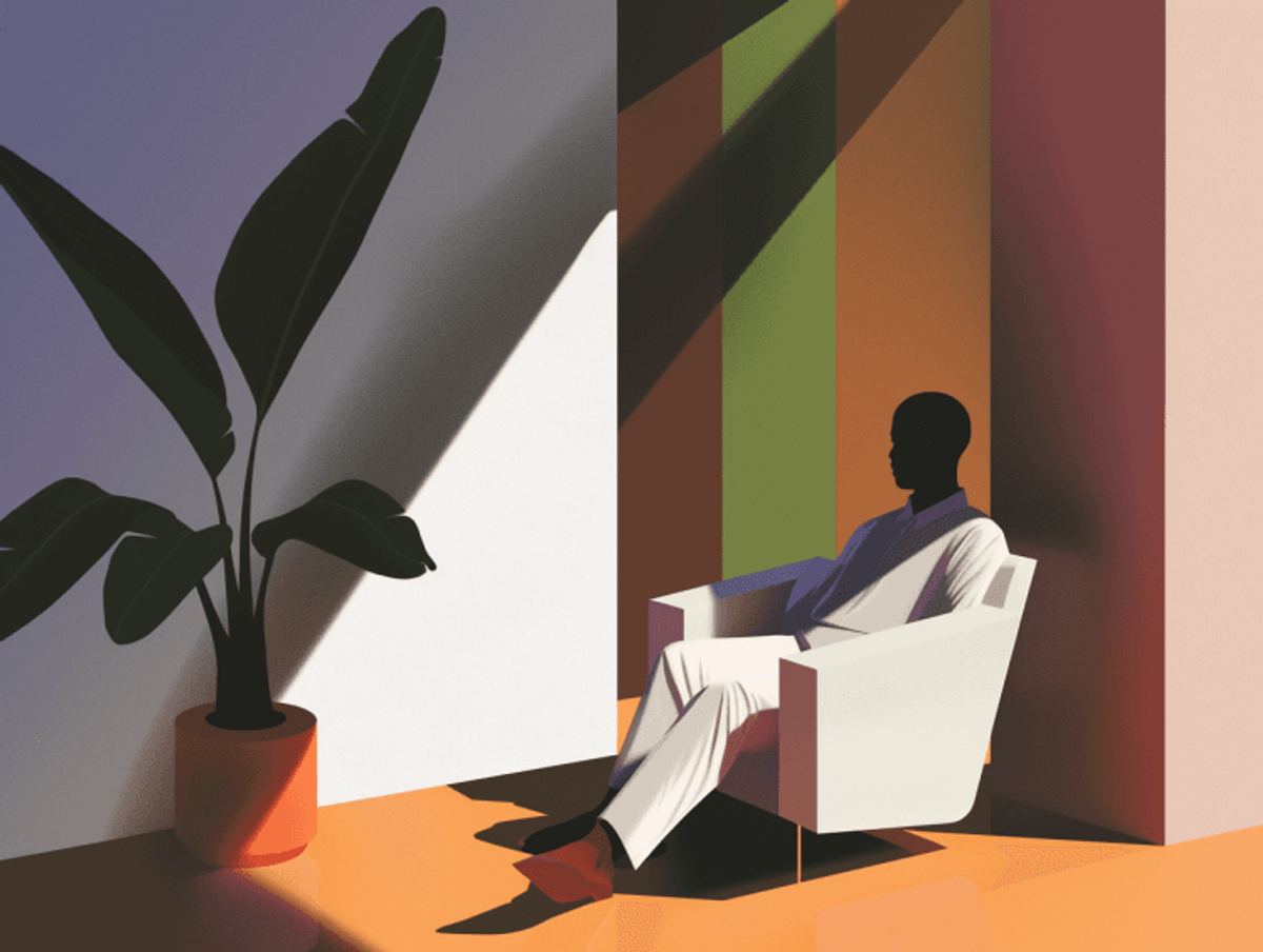 Person sitting in a chair next to a plant