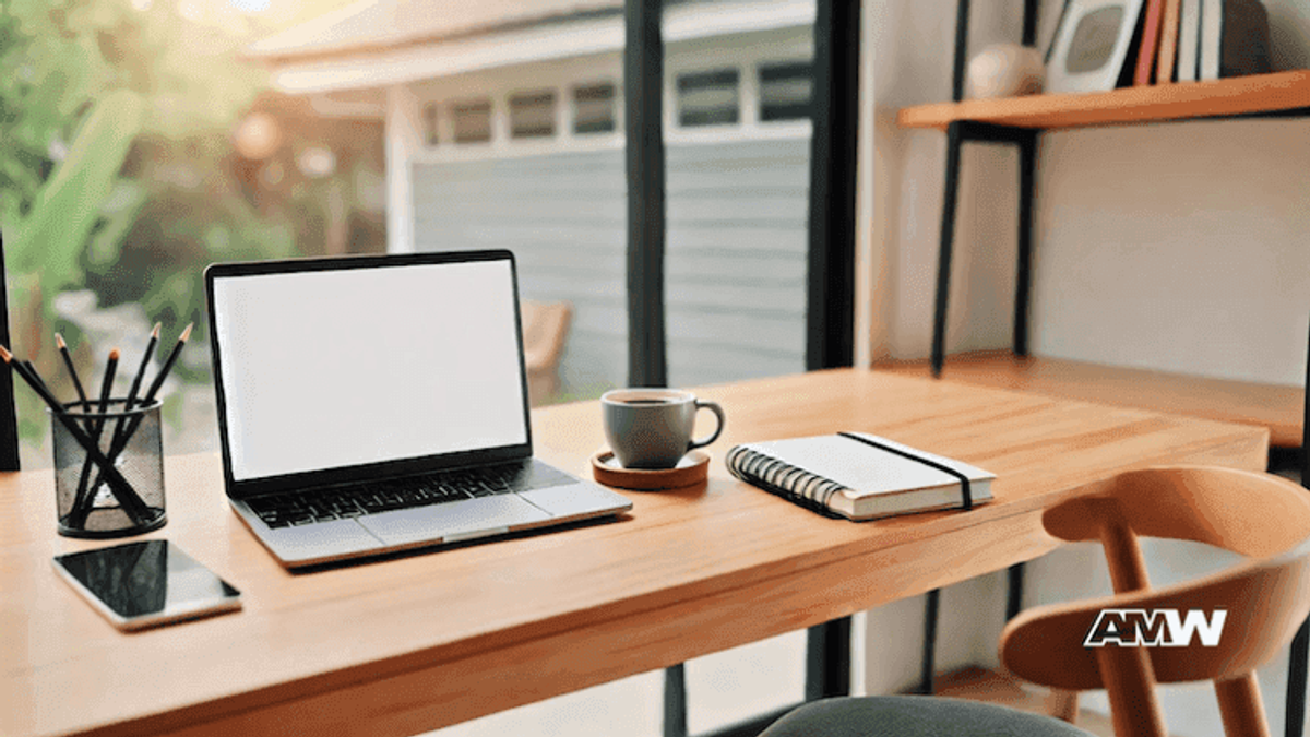 Home office desk with laptop and coffee cup.