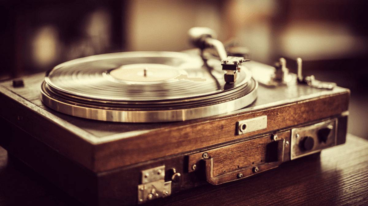 Vintage turntable playing vinyl record.