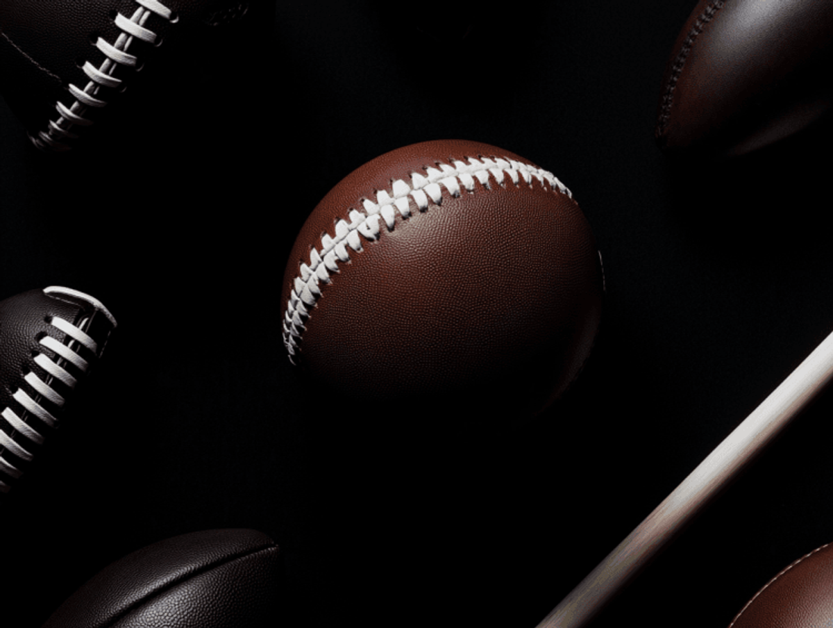 Closeup of American footballs on black background.