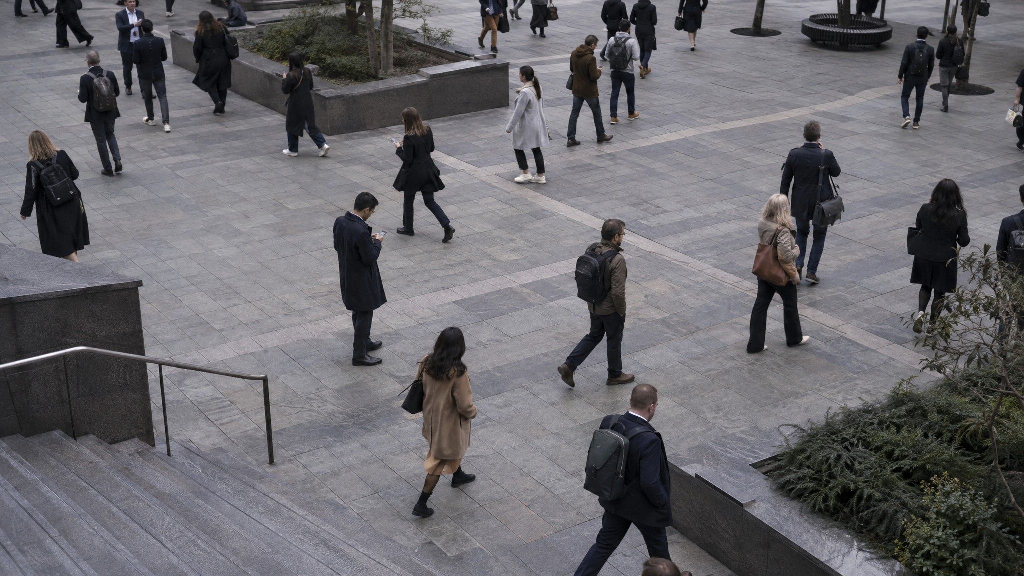 City plaza at lunchtime seen from above with people crossing