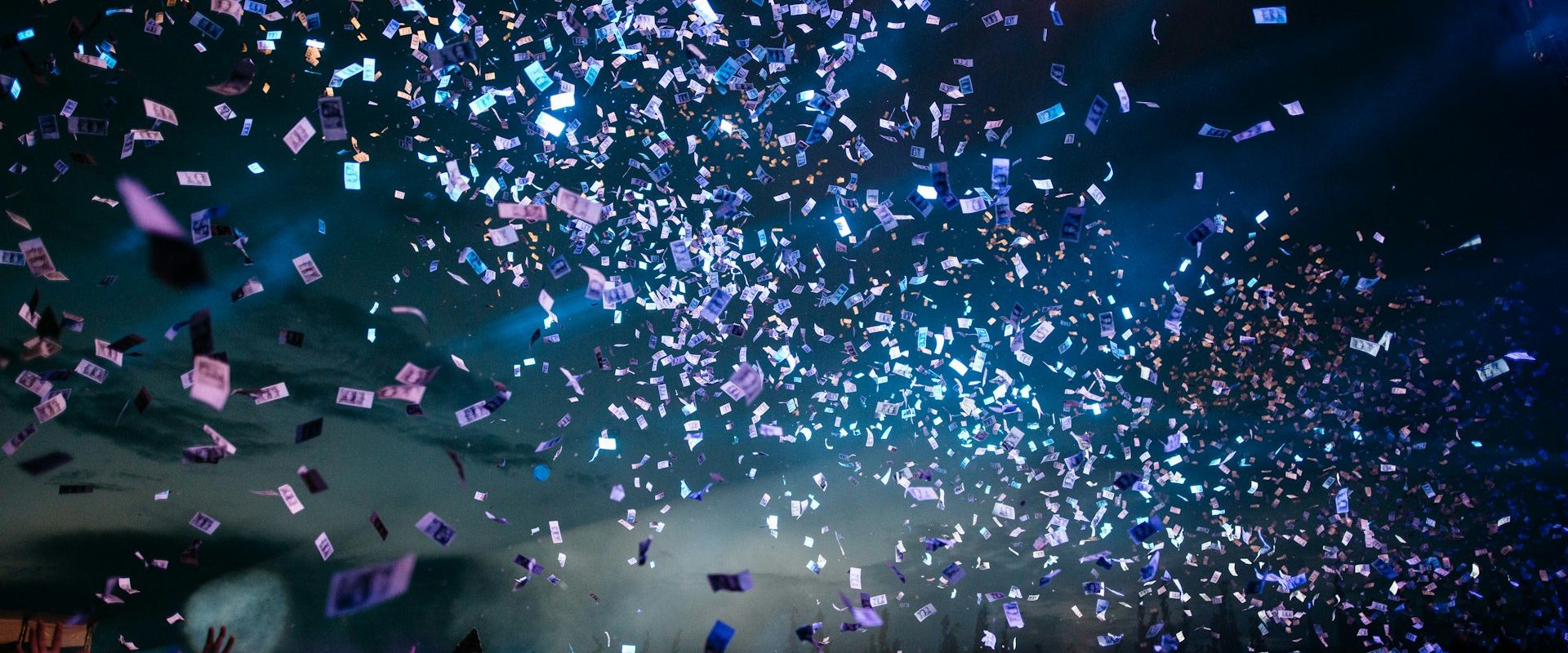 Large-scale corporate event with dramatic stage lighting and a packed venue