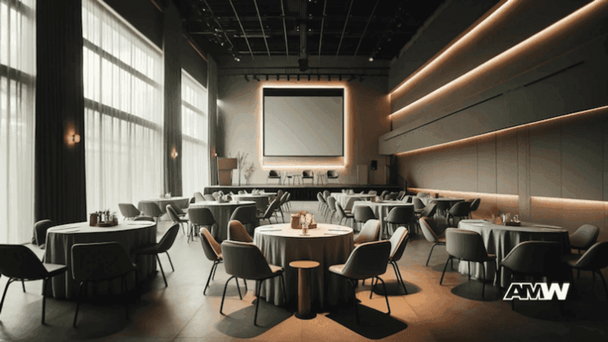 Spacious conference room with round tables and chairs.