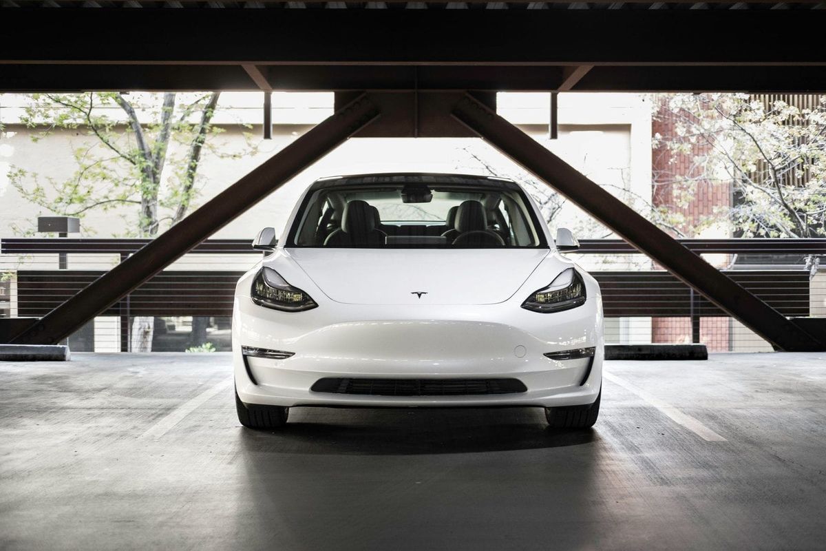 White car parked under structure