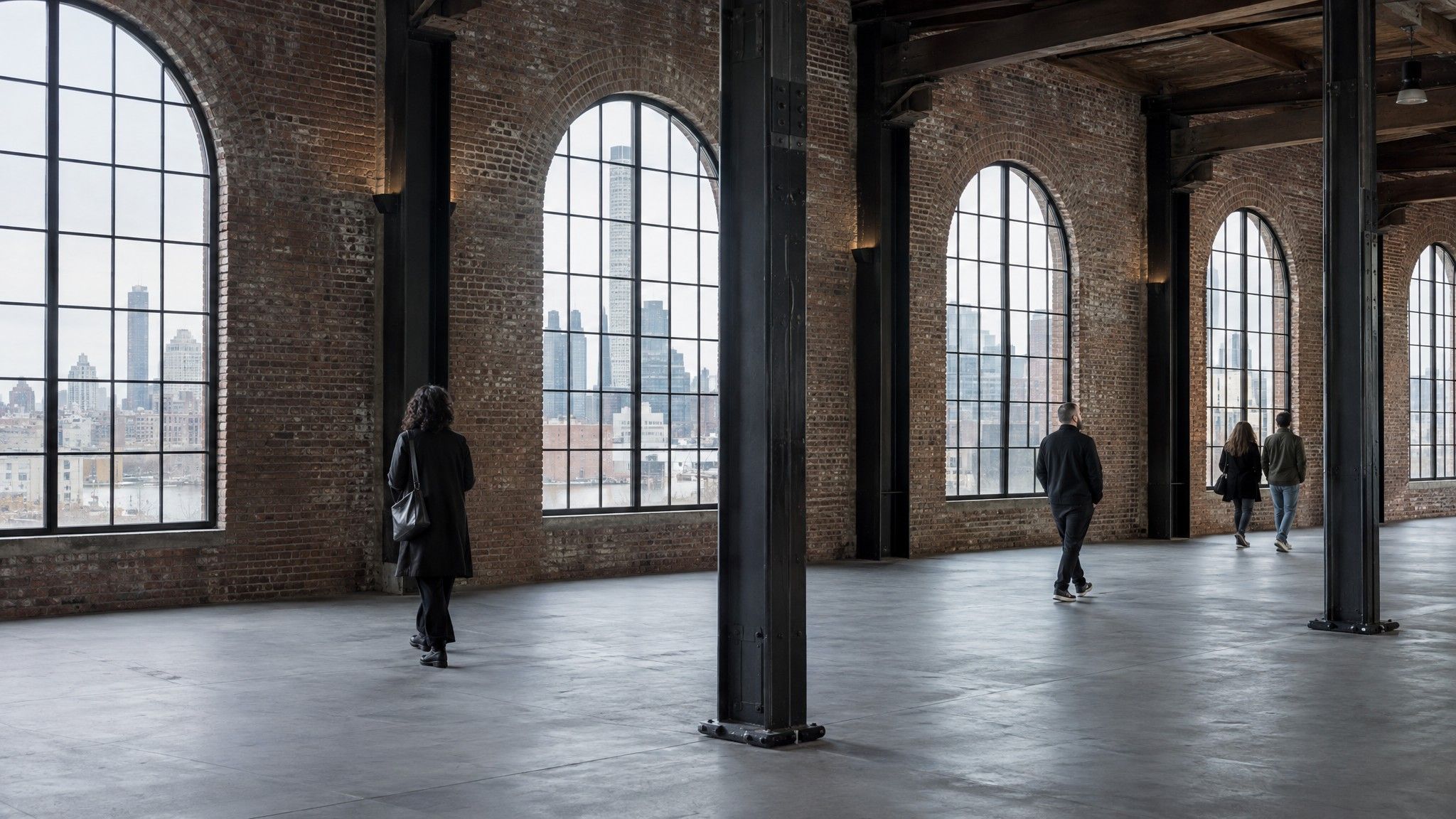 Empty industrial event venue with brick walls and arched windows