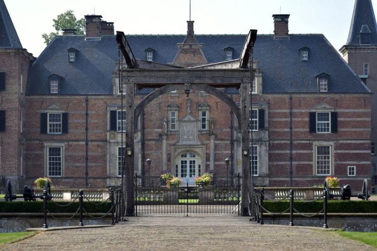 Historic castle with drawbridge and cannons.