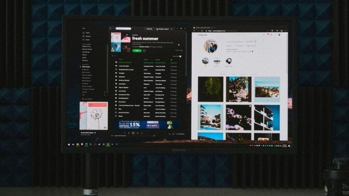 Monitor displaying Spotify and Instagram interfaces