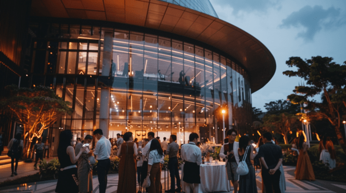 Evening gathering outside modern glass building.