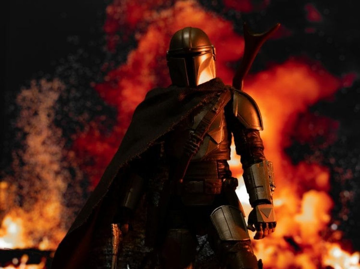 Armored character with cape in fiery background.