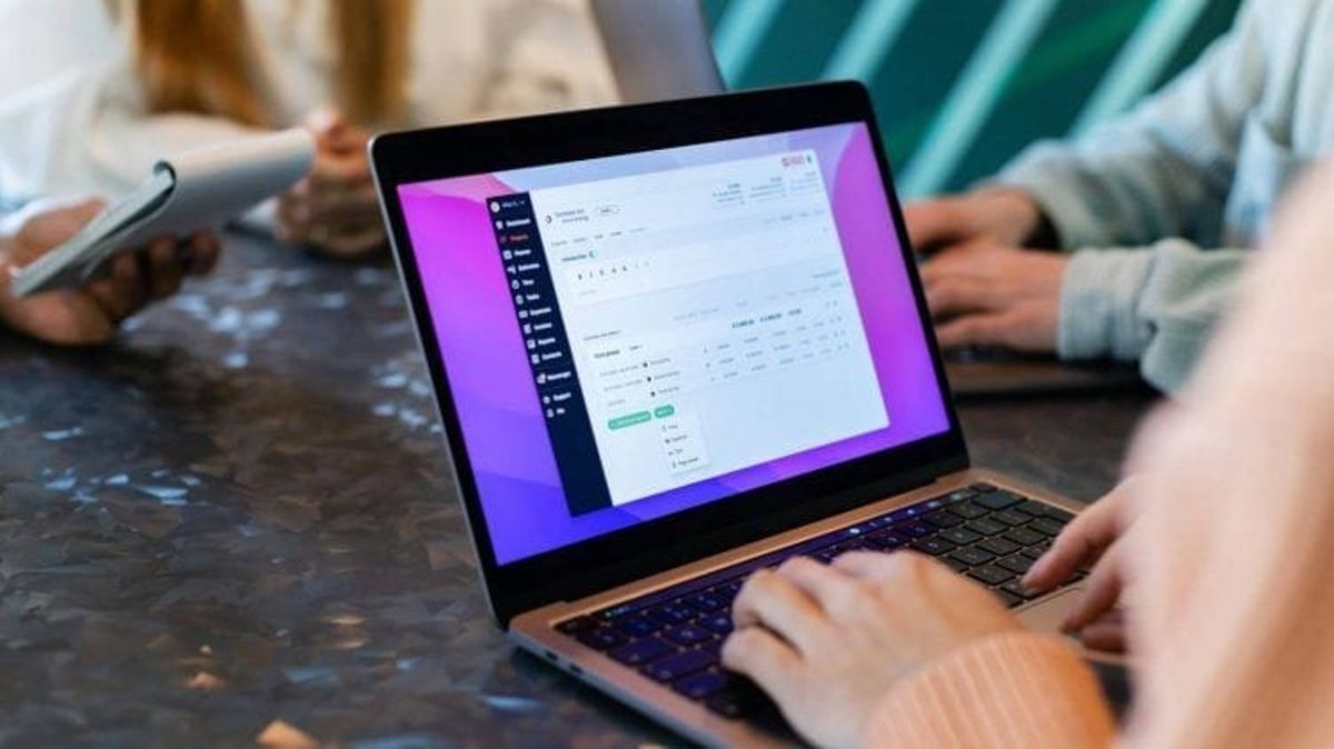 Person using a laptop with dashboard on screen.