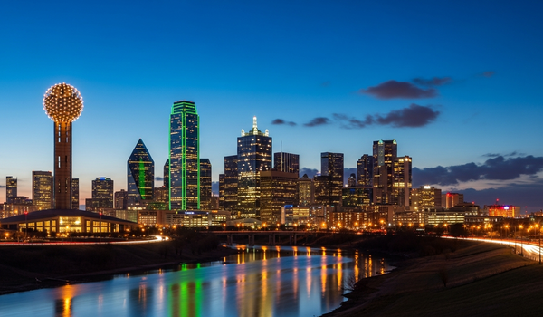 Dallas skyline with Reunion Tower at twilight reflecting on Trinity River