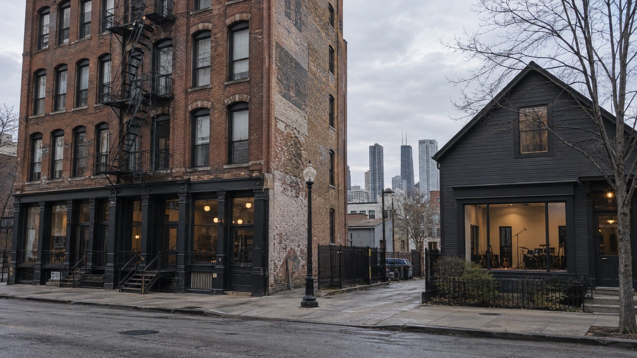 Tall brick building opposite a small converted home studio
