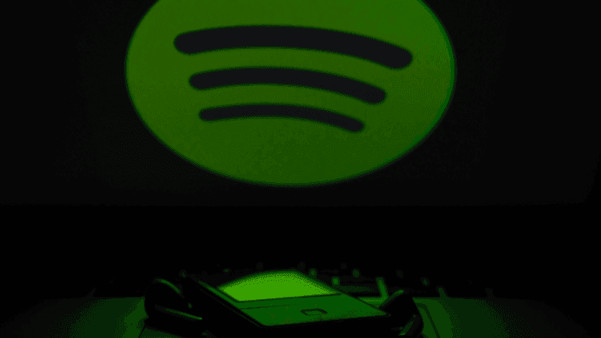 Spotify app on smartphone with logo background