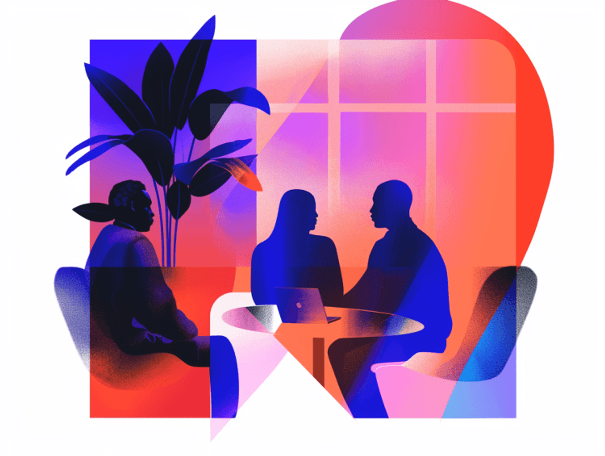 People discussing around a table with laptop