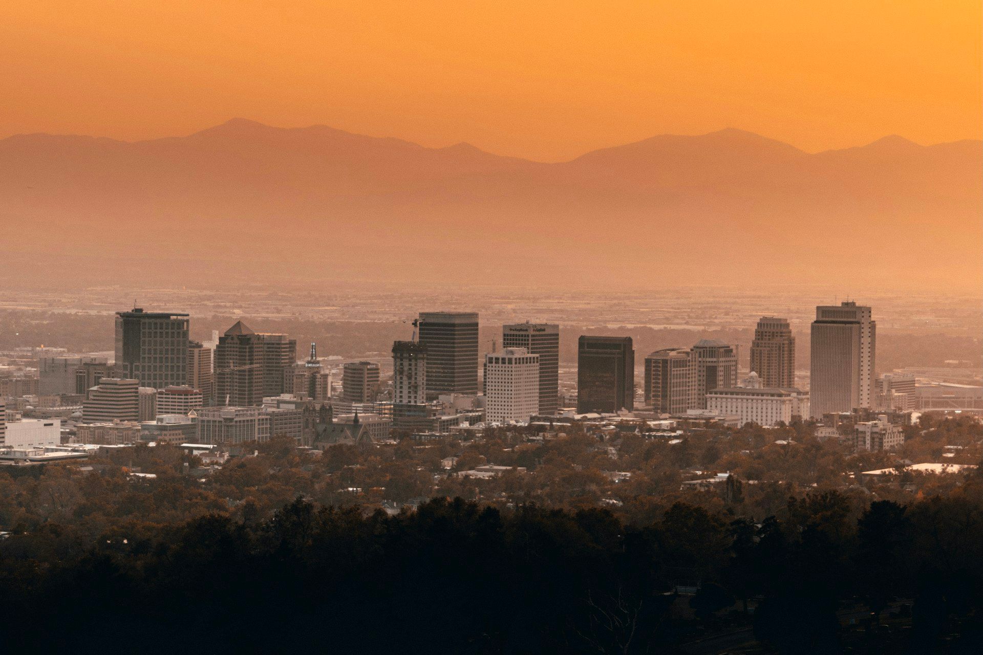 Salt Lake City downtown skyline with mountains under blue sky