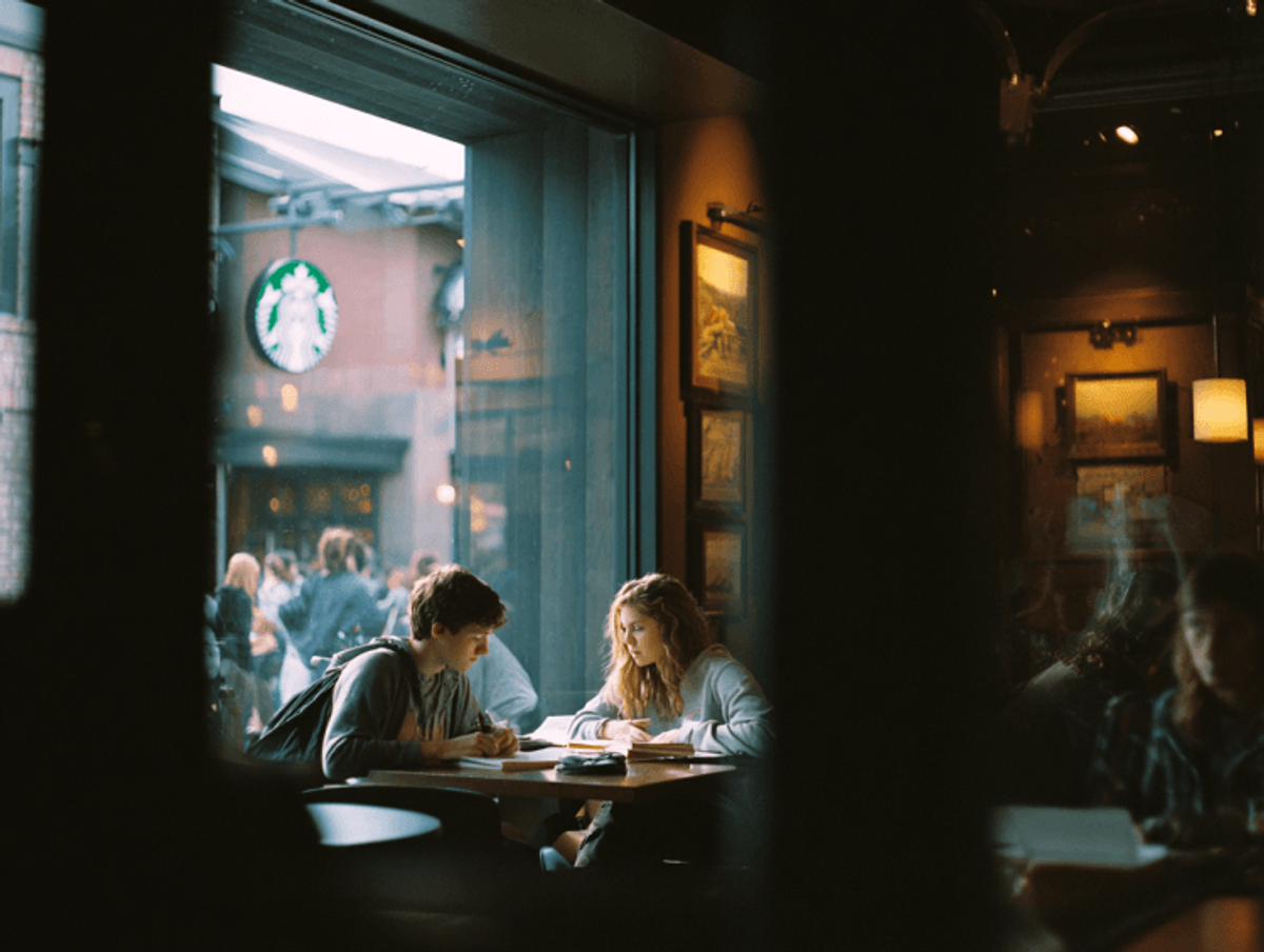Two people studying in a coffee shop.